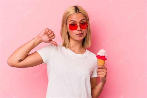 Premium Photo Young Venezuelan Woman Eating An Ice Cream Isolated On Pink Background Feels