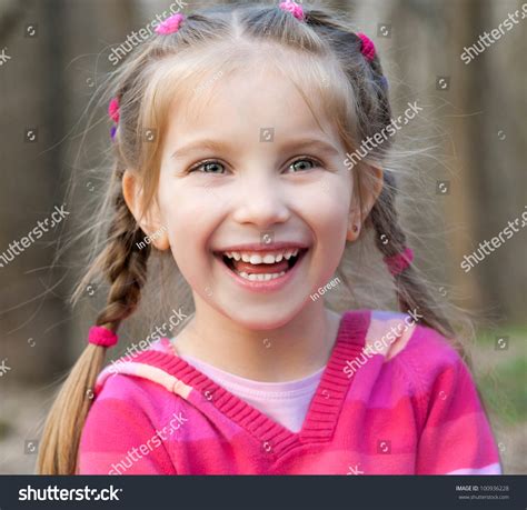 Cute Little Girl Smiling In A Park Close Up Stock Photo 100936228
