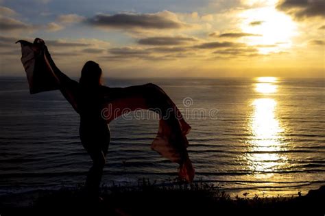 Lovely Brunette Bikini Model Relaxing On The Shoreline At Sunset Stock