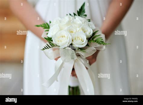 Bride Holding Wedding Flower Bouquet Of White Roses Stock Photo Alamy