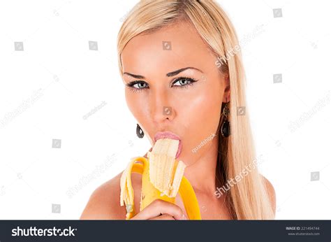Attractive Blond Woman Sexy Eats Banana Stock Photo