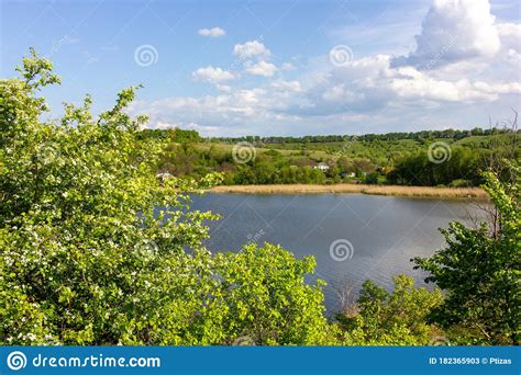 Idyllic Summer Landscape With River Hill Green Trees Blue Sky And