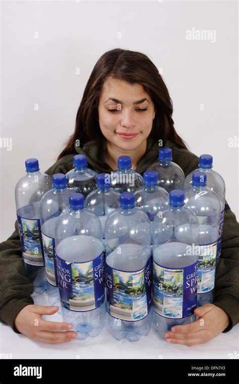 Teenage Girl Posing With 12 Plastic Bottles To Illustrate The Recycling
