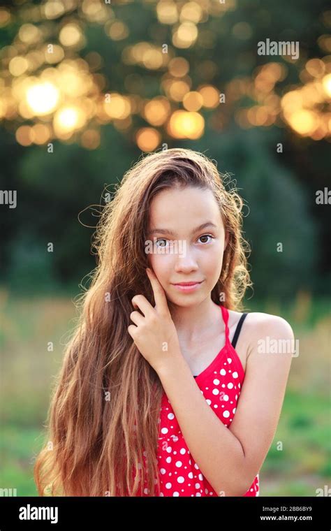 Beautiful Teen Girl Is Smiling And Enjoying Nature In The Park At