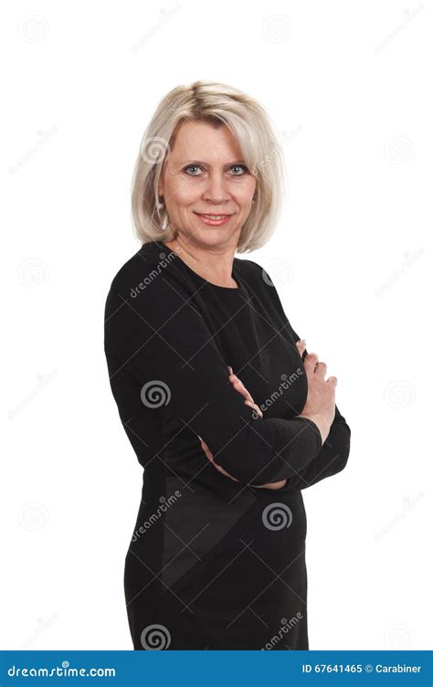 Mature Businesswoman Standing With Arms Crossed Against Stock Image