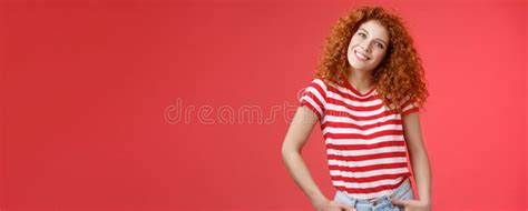 cheerful european redhead fashionable happy redhead curly haired girl tilt head excited hold