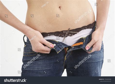 Woman Unzipping Her Jeans Conceptual Image Stock Photo Edit Now