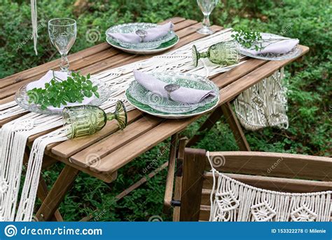 A boho chic tablescape with black napkins and candles, wicker chargers, geometric touches, dried florals and pampas grass. Boho Style Wedding Reception Dinning Table With Macrame Tablecloth Stock Photo - Image of ...