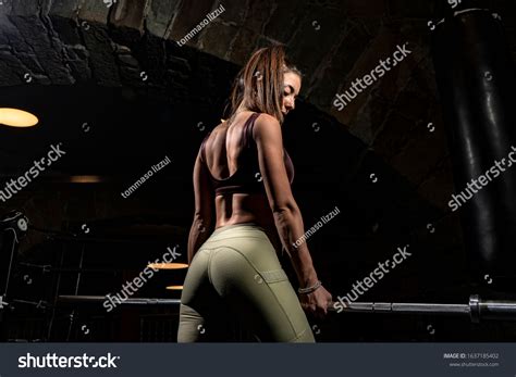 Strong Fitness Woman Bodybuilder Pumps Muscles Stock Photo