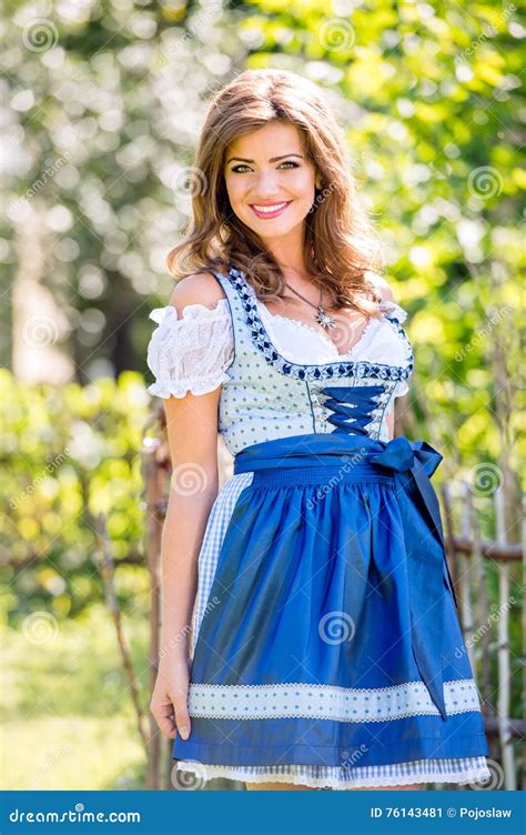 Beautiful Young Woman In Traditional Bavarian Dress In Park Stock Image