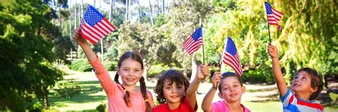 Premium Photo Children Holding American Flag While Sitting In Park