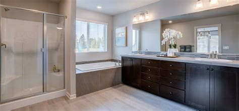 A Large Bathroom With Two Sinks And A Bathtub Next To A Walk In Shower