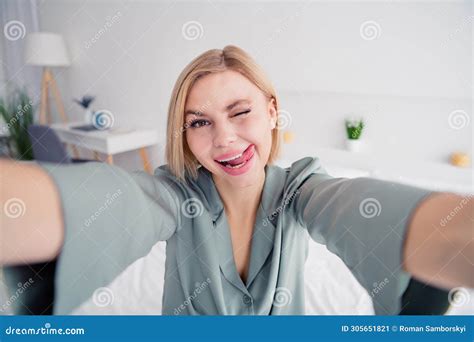 Self Portrait Of Young Playful Coquette Lady Wearing Grey Pajama Lick Teeth Tongue Out Blinking