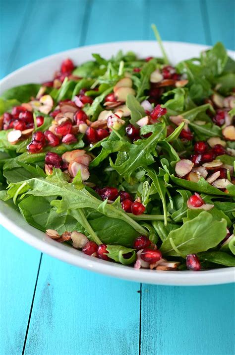 Vegan spinach salad is a classic recipe that pairs perfectly with sweet and tangy maple balsamic dressing! Recipe for Spinach, Arugula, Almond and Pomegranate Salad - Life's Ambrosia Life's Ambrosia