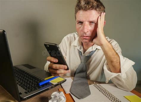 Sad Desperate Man In Lose Necktie Messy And Depressed Working At Laptop