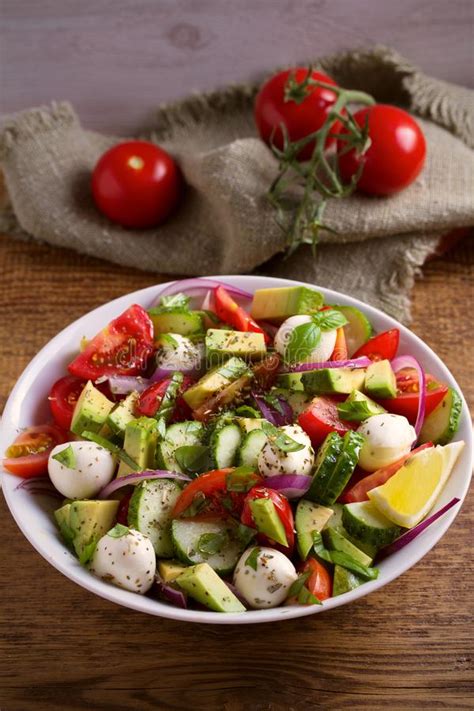 Chop tomatoes, cucumber, and red onion. Avocado, Tomato, Cucumber Salad With Mozzarella Cheese In ...
