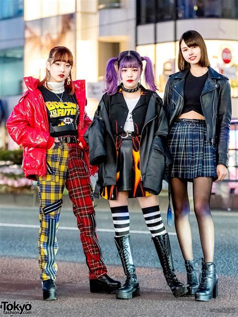 harajuku girl trio in streetwear styles w plaid punk pants flame print shirt and plaid skirt