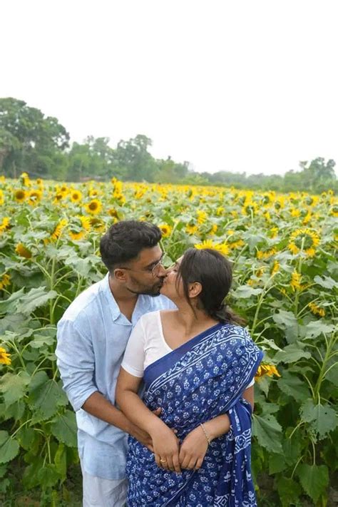 desi couple kiss with sunflower photography