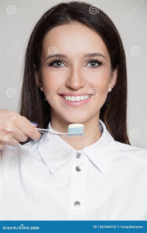 Portrait Of Dentist Smiling Woman Holding Toothbrush In Hand Stock