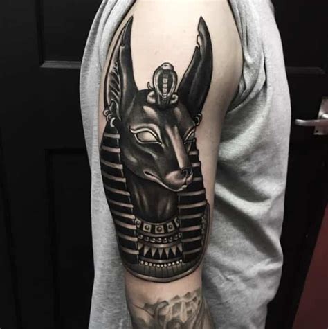 It has a simple text saying roman 8:18. 15 Cool Anubis Tattoo Designs for Inspiration - SheIdeas