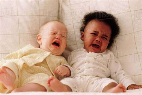 Two Babies Crying On A Couch Stock Photo Dissolve
