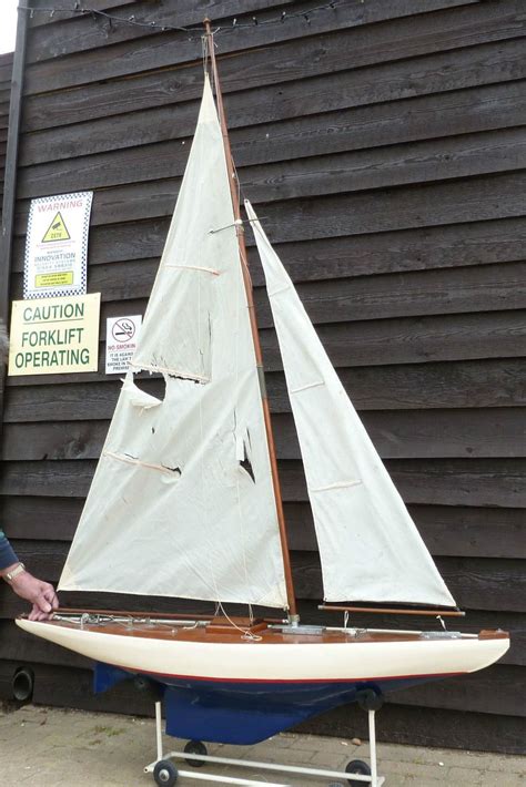 A Model Sailboat Is On Display In Front Of A Building