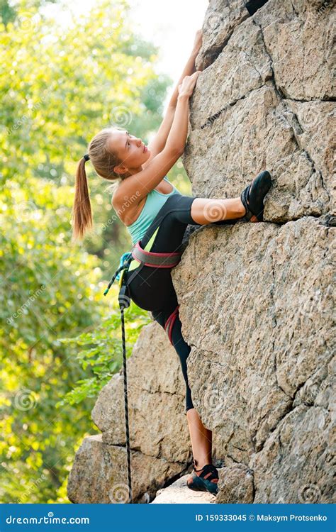 Beautiful Woman Climbing On The Rock In The Mountains Adventure And Extreme Sport Concept Stock