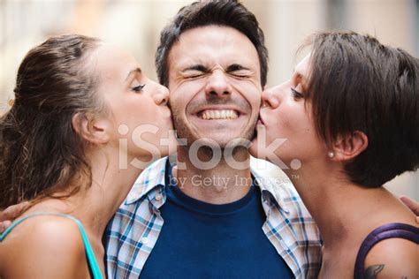 Happy Guy Gets A Kiss From Two Girls Stock Photo Royalty Free