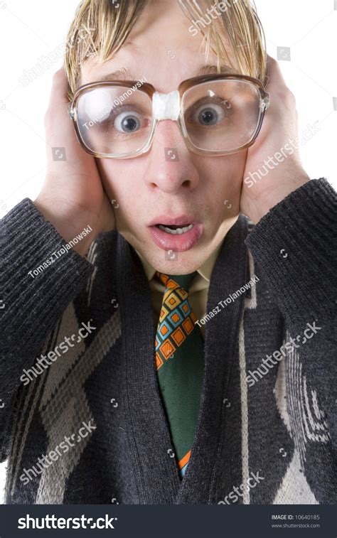 Scared Nerd With Funny Glasses Looking At Camera And Covering His Ears