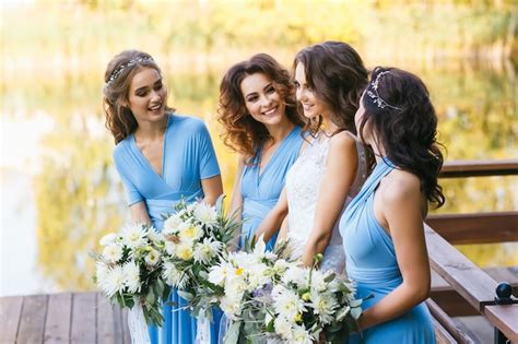 Premium Photo Bride With Bridesmaids On The Park On The Wedding Day