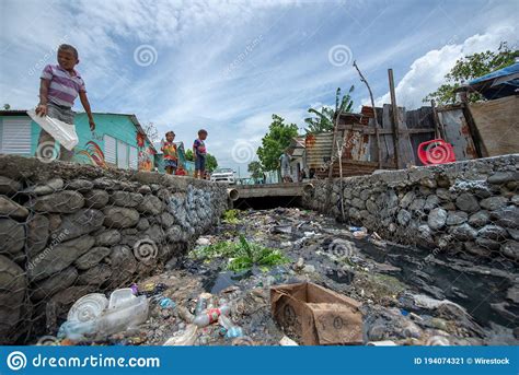 Children Playing Near The Aqueduct Full Of Garbage And Waste By The