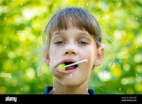 The Girl Has A Big Round Lollipop In Her Mouth Close Up Portrait Stock