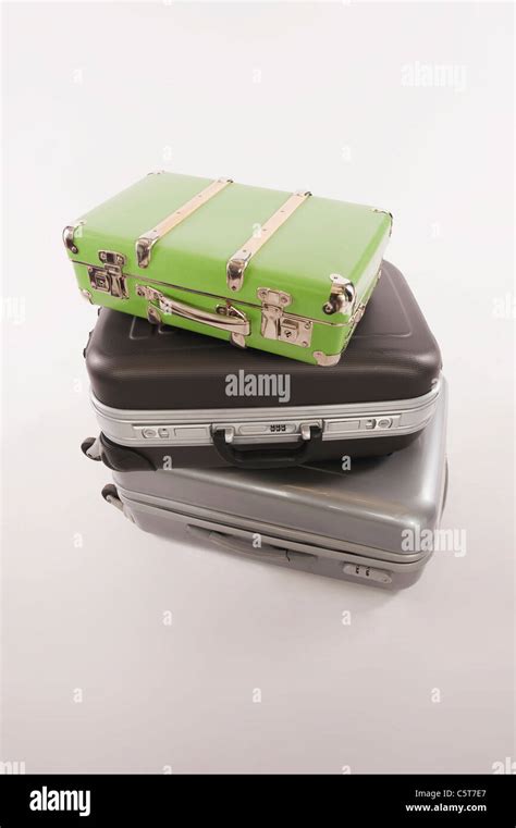 Stack Of Suitcases And Luggages Against White Background Stock Photo