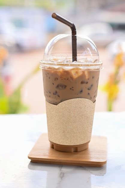 Premium Photo Iced Coffee In Take Away Cup Plastic Glass On The Wood