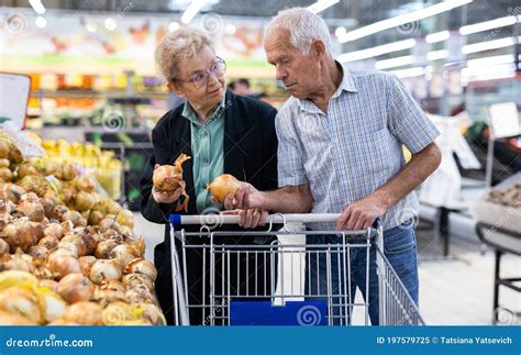 mature spouses chooses potato in vegetable section of supermarket stock image image of