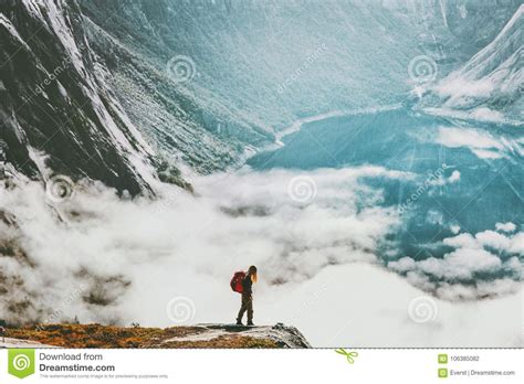 Traveler With Backpack Hiking Above Clouds And Lake Stock Photo Image