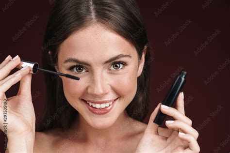 Image Of Smiling Half Naked Woman Looking At Camera And Using Mascara Stock Photo Adobe Stock