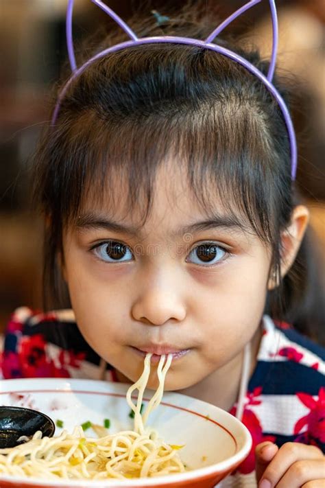 Female Asian Child While Eating Noodles Child Eating Ramen Noodles