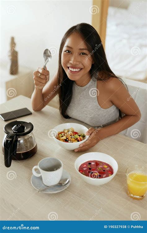 Woman Eating Healthy Breakfast At Home In Morning At Table Stock Photo