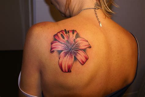 Amazing Lily Flower Tattoo On Girl Back Shoulder