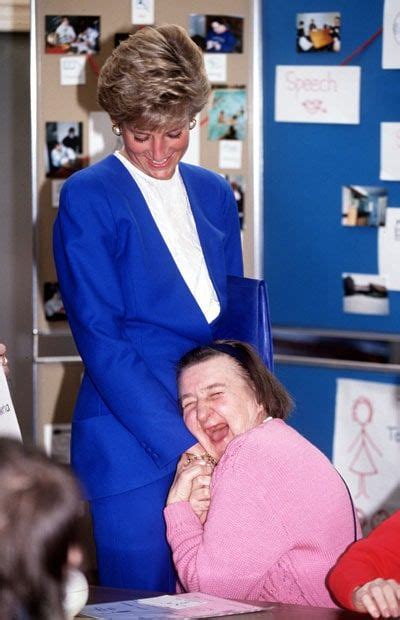 A Woman In A Blue Suit Laughing Next To A Lady With Her Hand On Her Face