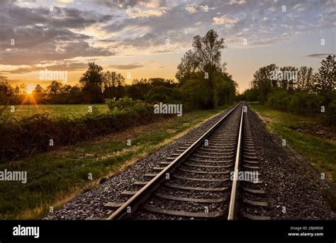 Railroad Tracks In Colorful Nature Against A Beautiful Sunset Sky Rail