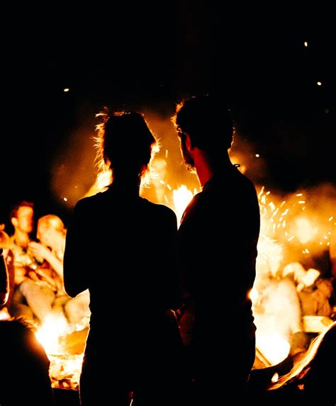Two Persons Standing In Front Of Bonfire Photo Free Fire Image On