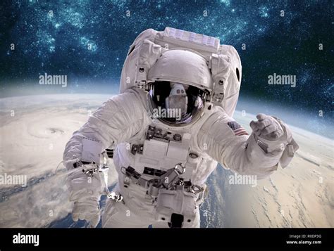 Astronaut In Outer Space Against The Backdrop Of The Planet Earth