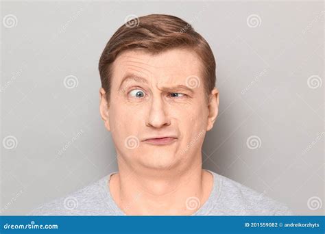 Portrait Of Funny Confused Man With One Eyebrow Raised Stock Photo