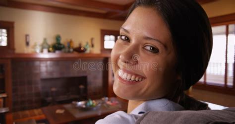 white millennial woman sitting on couch smiling at camera stock image image of beautiful cute
