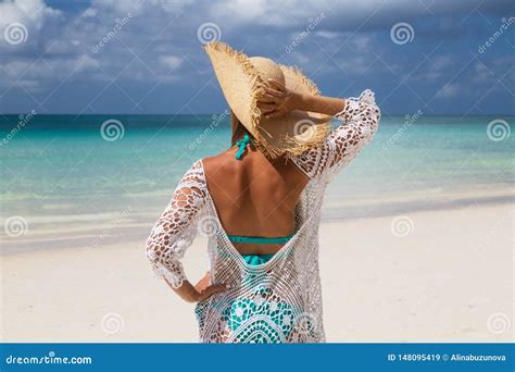 Tanned Girl In Blue Bikini Straw Hat Standing From Behind On The My