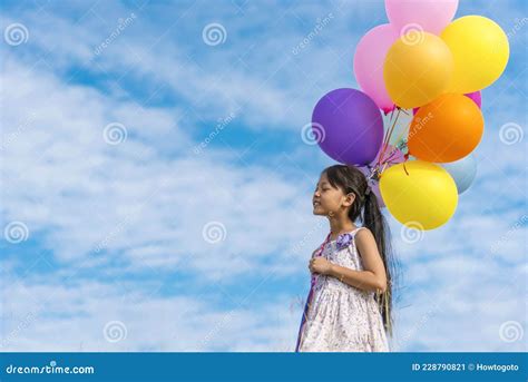 Cheerful Cute Girl Holding Balloons Running On Green Meadow White Cloud