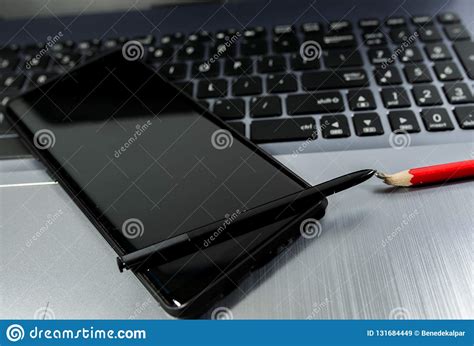 Modern Mobile Phone On Laptop Computer Keyboard Broken