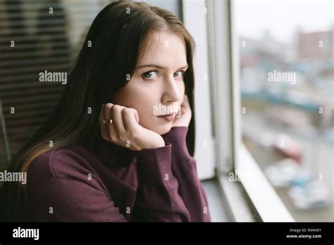 Sad Woman Looking Through The Window Stock Photo Alamy